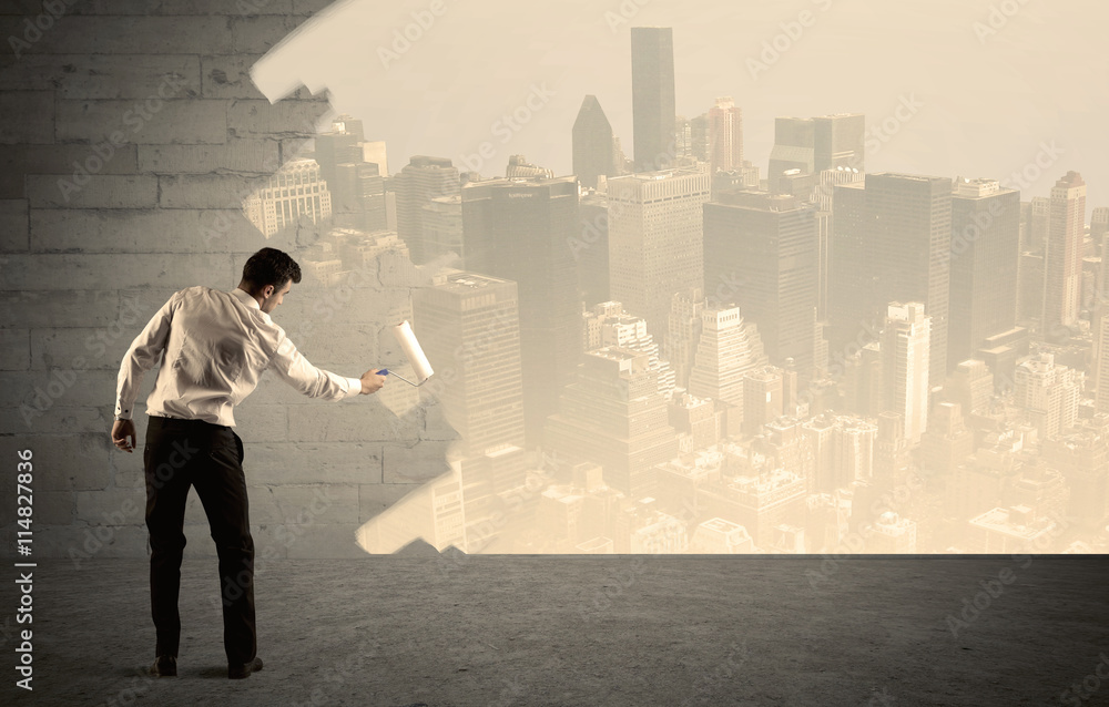 Salesman painting city scape on wall Salesman painting city scape on wall