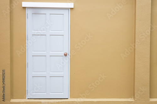 White door classic vintage on the color yellow wall background
