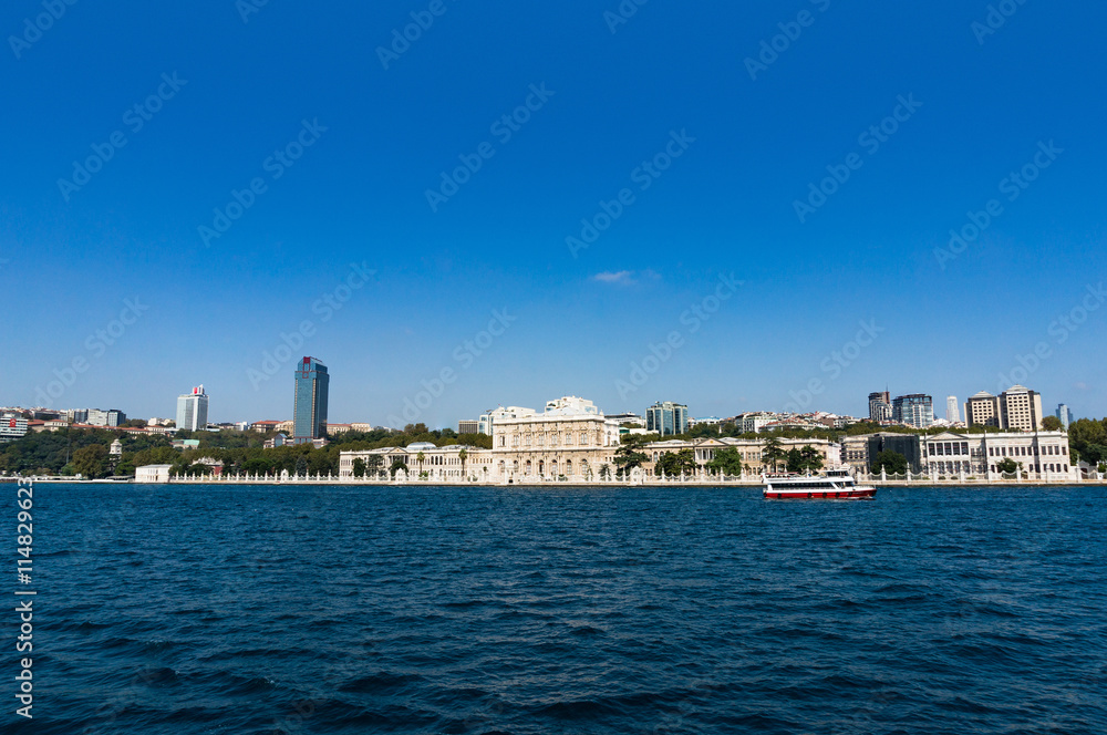 Cityscape with clear blue sky on the background. Modern buildings of Istanbul Besiktas district with Dolmabahce palace. Urban skyline landscape with copy space