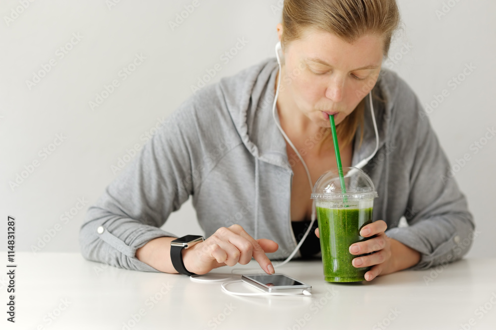 Green detox cup and woman before workout. Green detox cup and woman before workout.