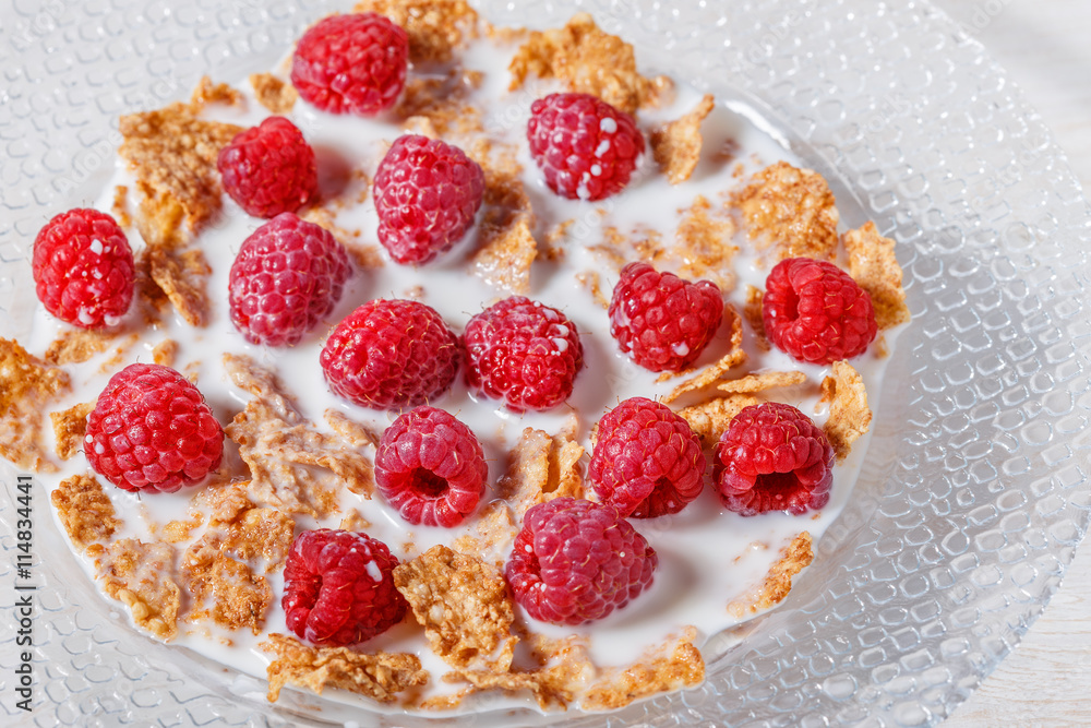 Wheat flakes with raspberries and milk. Wheat flakes with raspberries and milk.