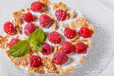 Wheat flakes with raspberries and milk.
