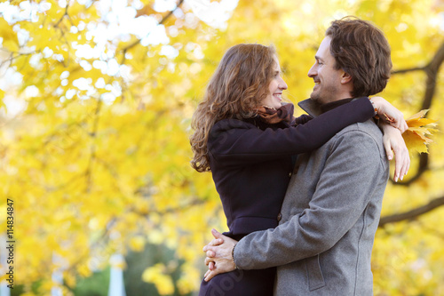 Couple hugging in autumn park
