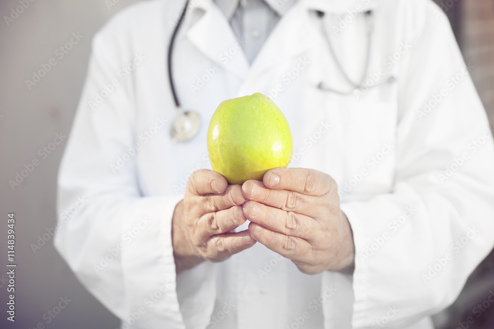 closeup of green Apple in the hand doctor nutritionist closeup of green Apple in the hand doctor nutritionist