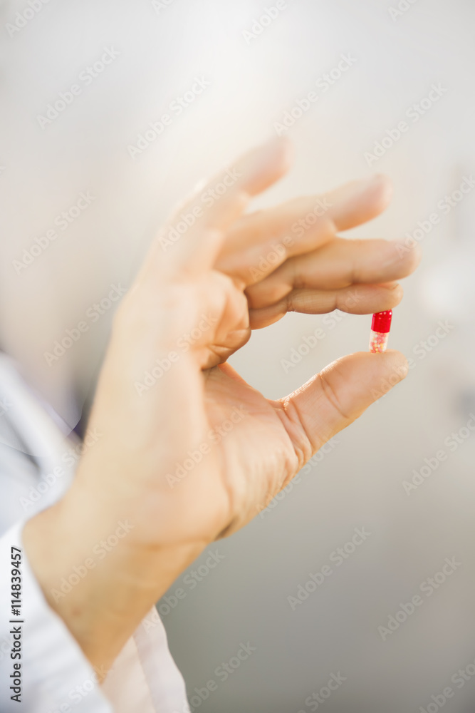 closeup medical pill in the hand of the doctor