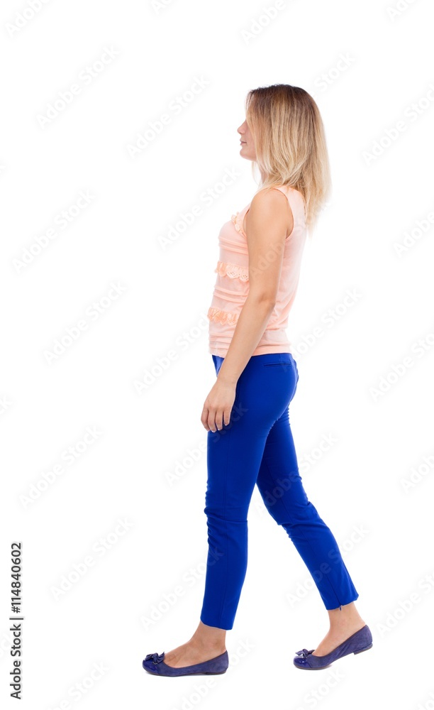 back view of walking woman. beautiful blonde girl in motion. b back view of walking woman. beautiful blonde girl in motion. b