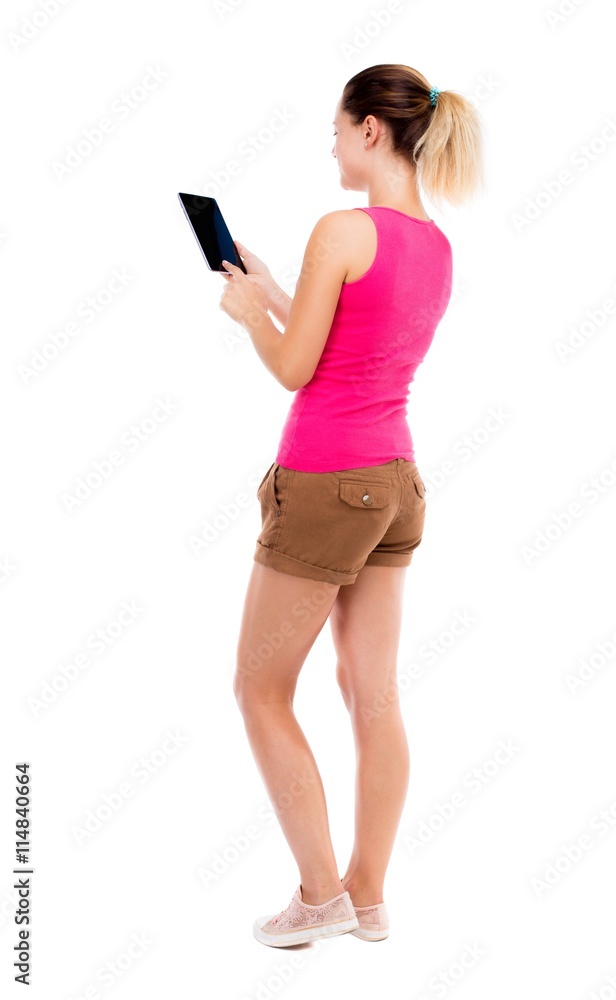 back view of standing young beautiful girl with tablet computer back view of standing young beautiful girl with tablet computer