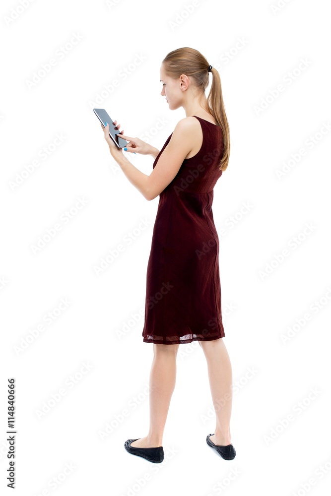 back view of standing young beautiful girl with tablet computer back view of standing young beautiful girl with tablet computer