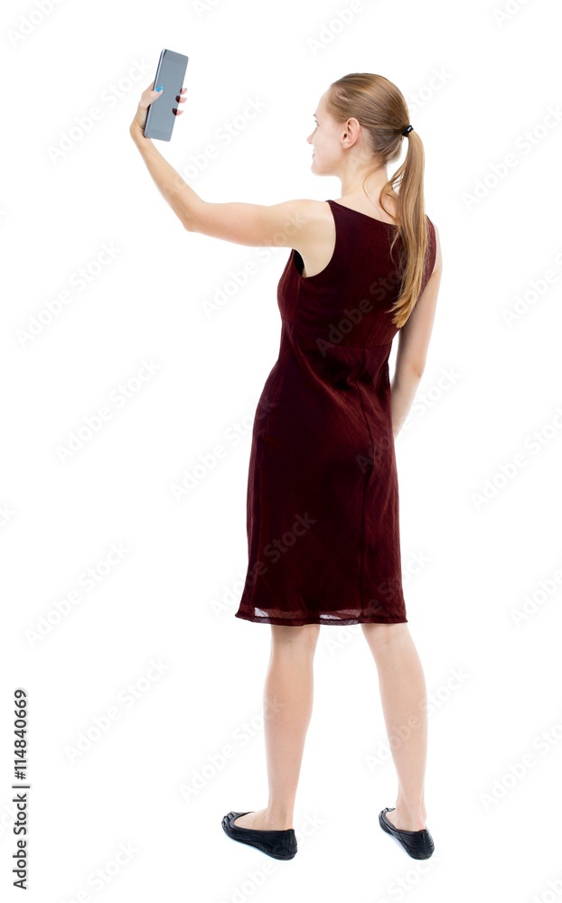 back view of standing young beautiful girl with tablet computer back view of standing young beautiful girl with tablet computer