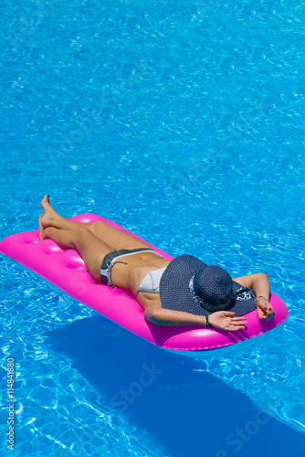 woman on a lilo at the swimming pool