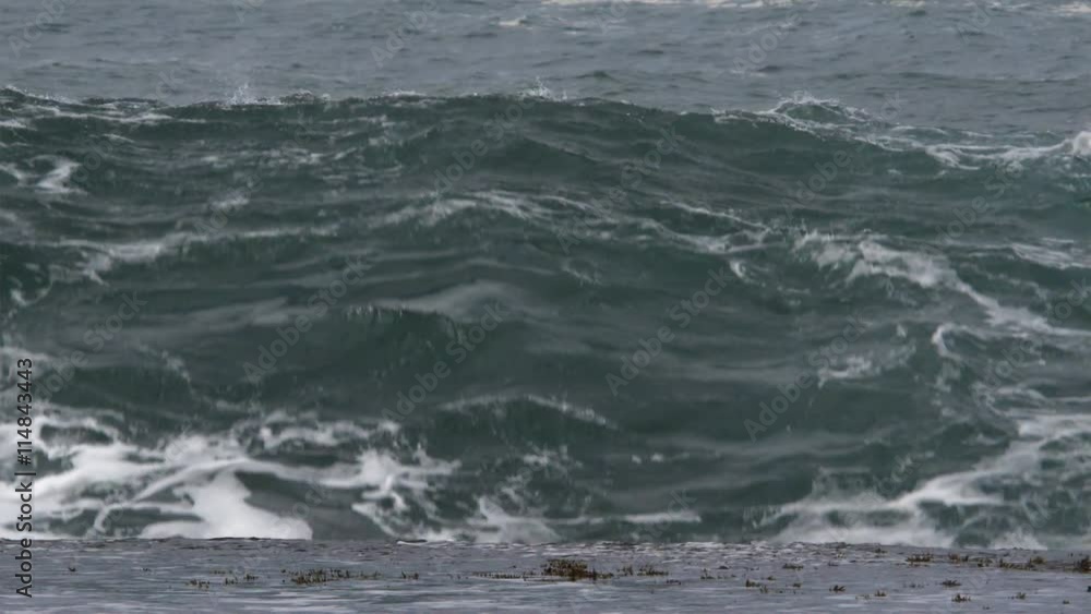 Close view of foaming waves breaking over rocky ledge Close view of foaming waves breaking over rocky ledge