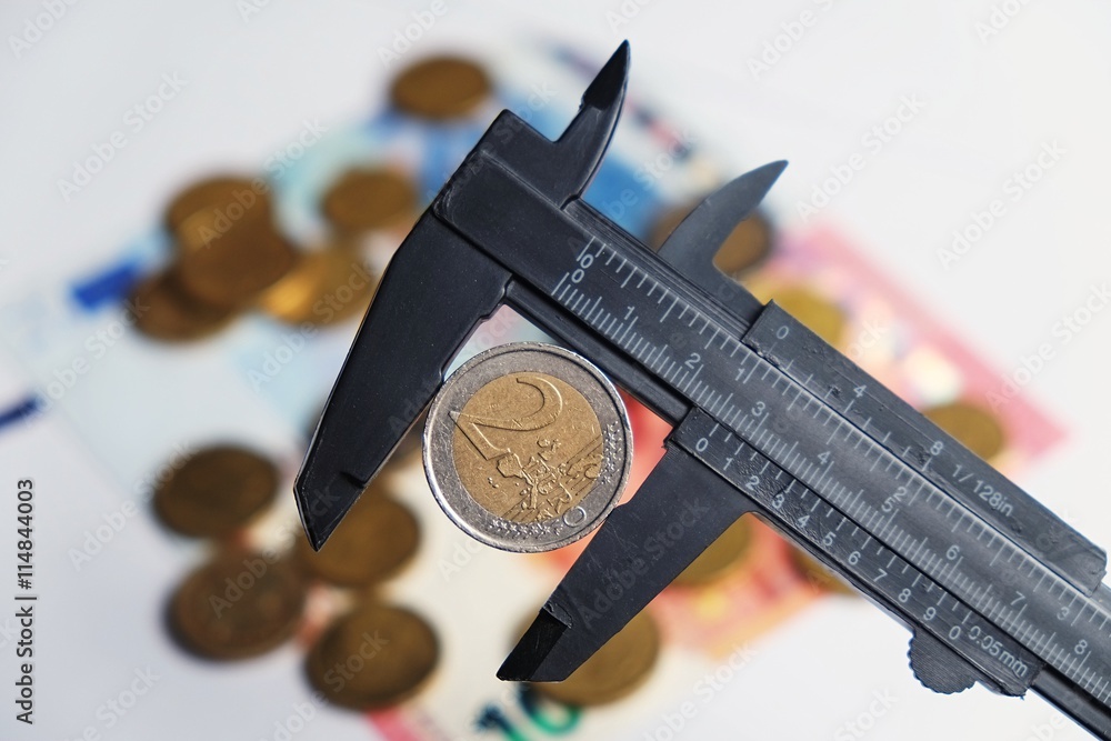 Measuring a 2 euros coin with a vernier tool Stock Photo | Adobe Stock