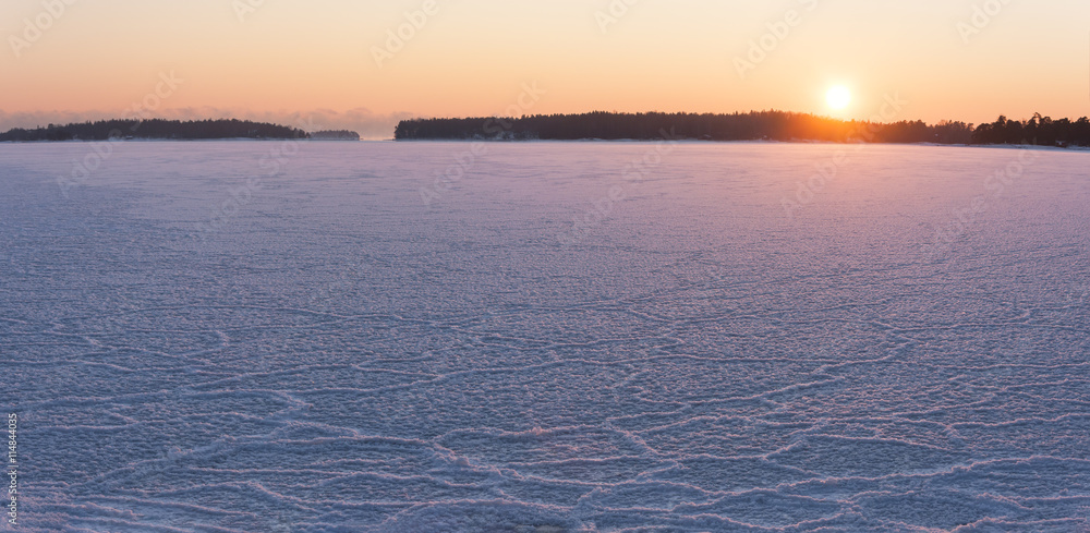 Winter sunset at frozen sea