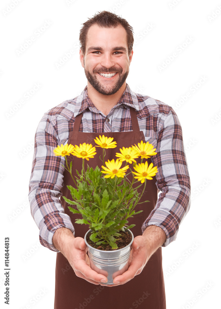 Smiling gardener holding flowers
