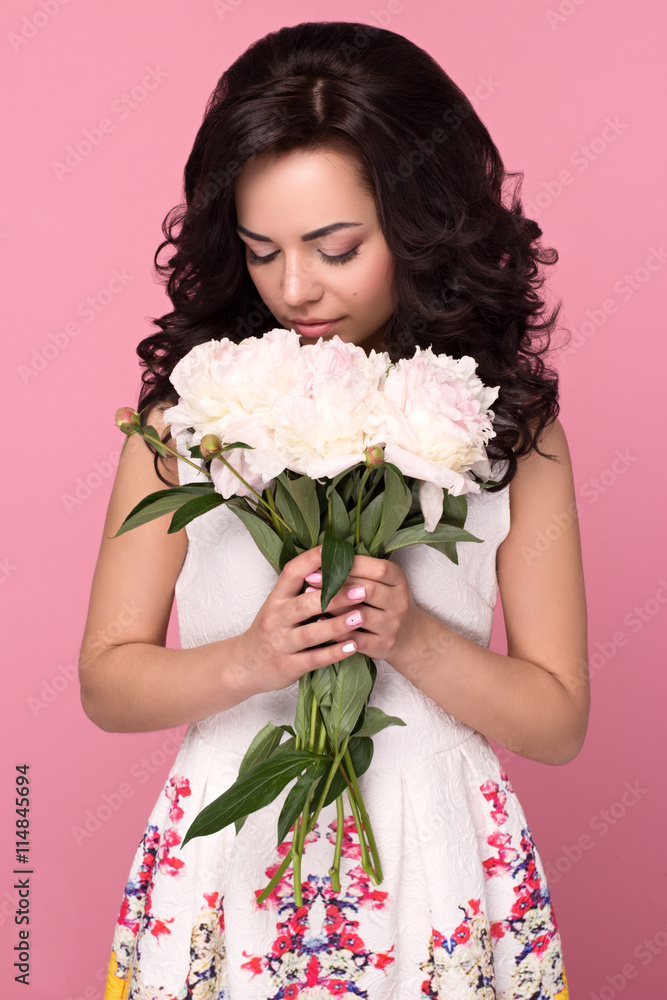Beautiful smiling girl with flowers on pink background Beautiful smiling girl with flowers on pink background