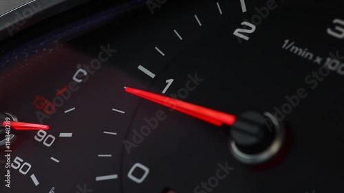 Close up footage of a car's tachometer reving. photo