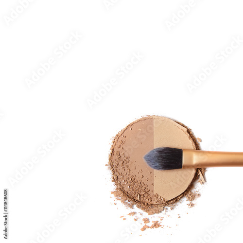 Broken bronze contour face powder with make up brush isolated on a white background forming a page border