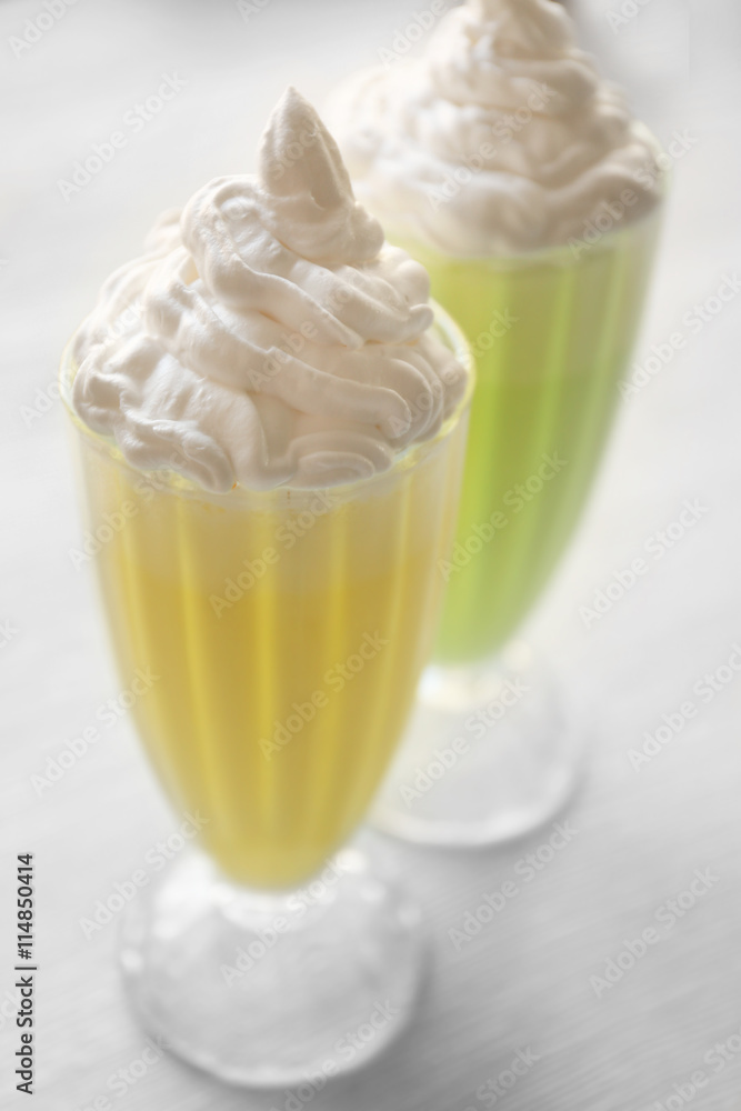 Delicious milkshakes on wooden table Delicious milkshakes on wooden table