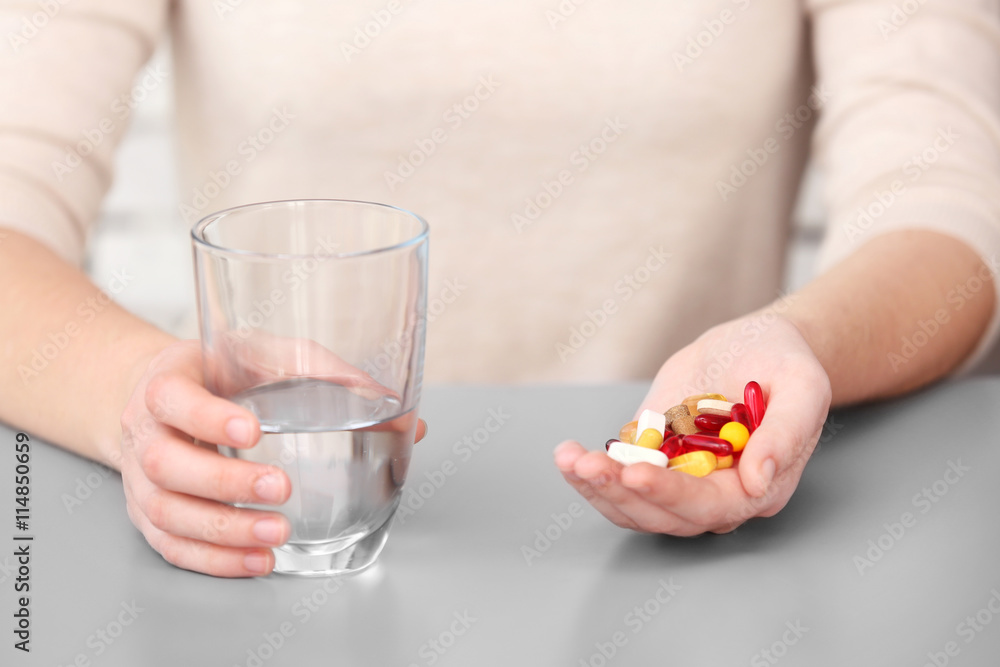 Woman taking vitamins, closeup Woman taking vitamins, closeup