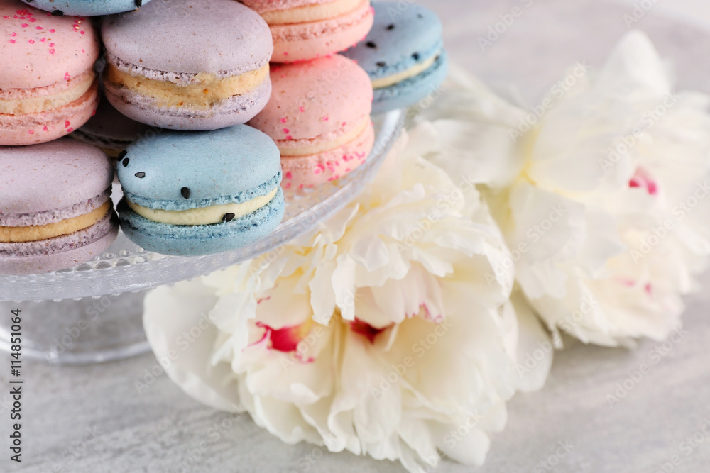 Tasty macaroons with beautiful peonies, closeup Tasty macaroons with beautiful peonies, closeup