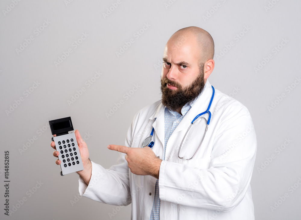 young doctor pointing to pocket calculator young doctor pointing to pocket calculator