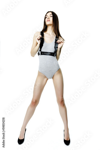 Young attractive woman wearing gray body with leather belt on white background