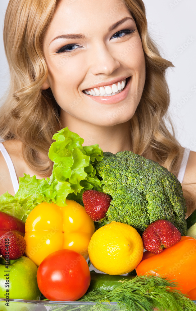 Young woman with vegetarian food, over gray Young woman with vegetarian food, over gray