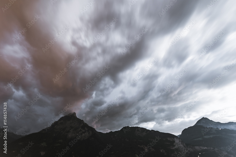 Sunset cloudy sky over mountains. Long exposure. Sunset cloudy sky over mountains. Long exposure.