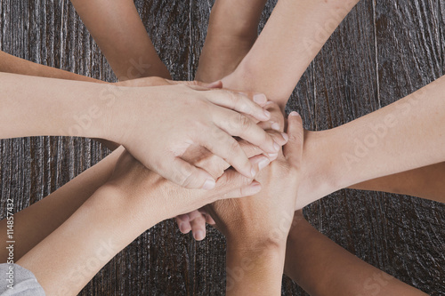 people put hand together for use as unity teamwork concept