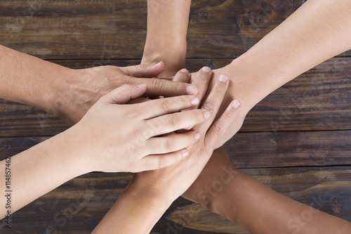 people put hand together for use as unity teamwork concept