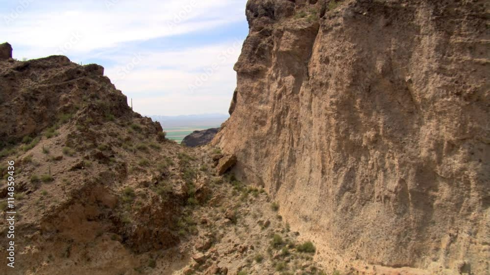 Flying through a notch in sandstone cliffs to reveal a wide valley. Shot in 2007. Flying through a notch in sandstone cliffs to reveal a wide valley. Shot in 2007.
