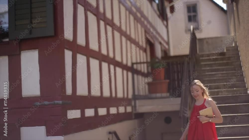 girl in a red dress with white hair down stairs girl in a red dress with white hair down stairs
