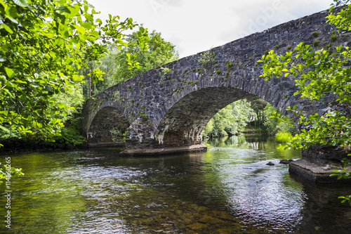 River Balvag with old arched stone bridge