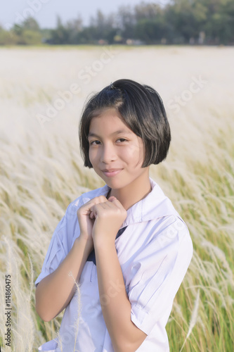 Thai girl student in white flower grassland