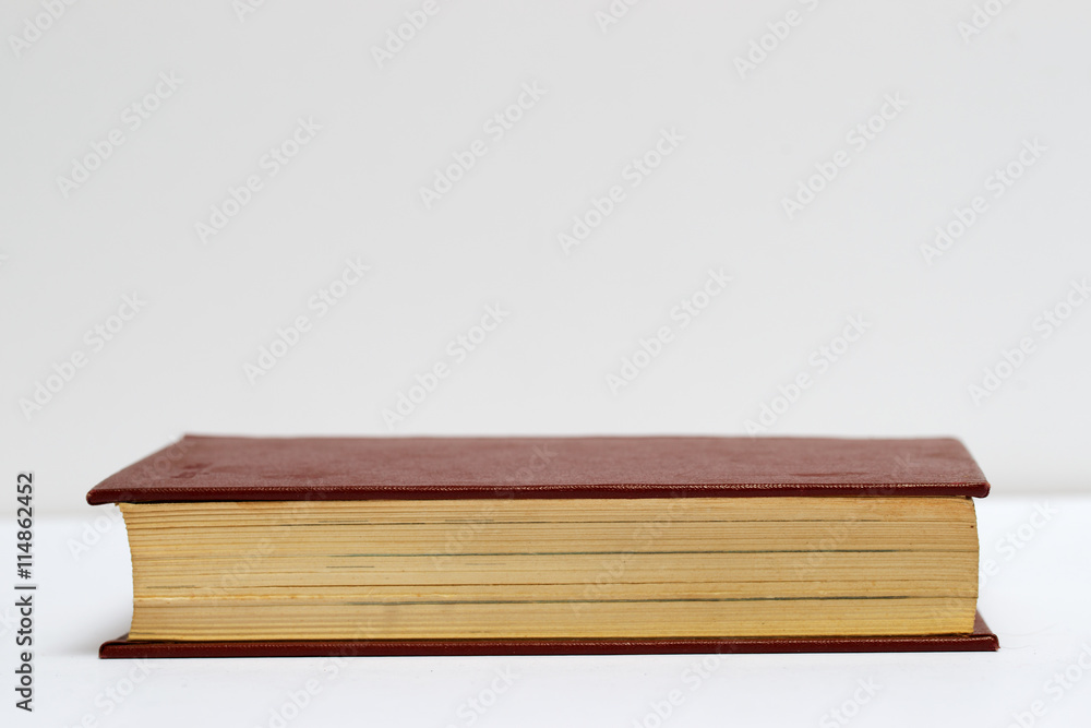 Hardback book on gray cloth. Back to school. Copy space Hardback book on gray cloth. Back to school. Copy space