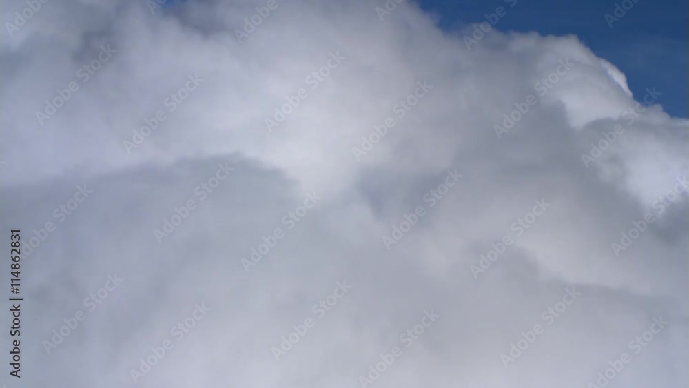 Fast flight alongside billowing cumulus, passenger POV Fast flight alongside billowing cumulus, passenger POV