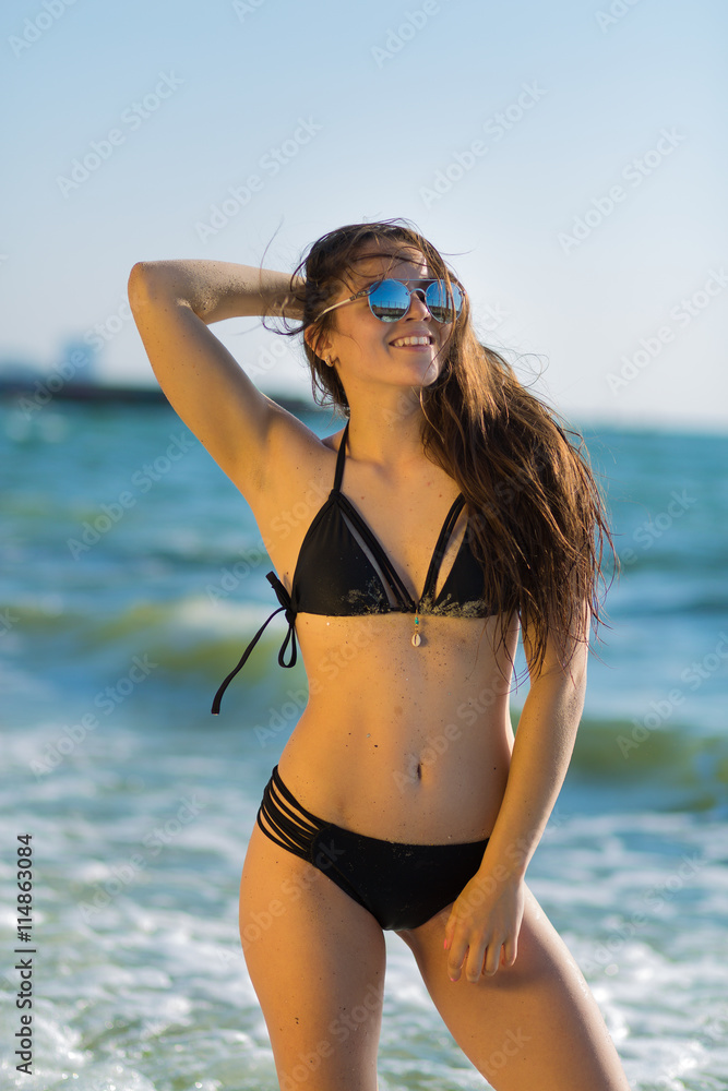 Beautiful young woman having fun at the beach