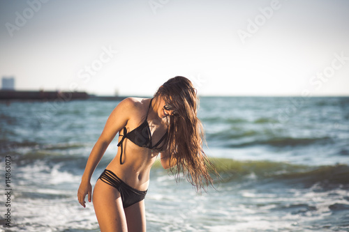 Beautiful young woman having fun at the beach