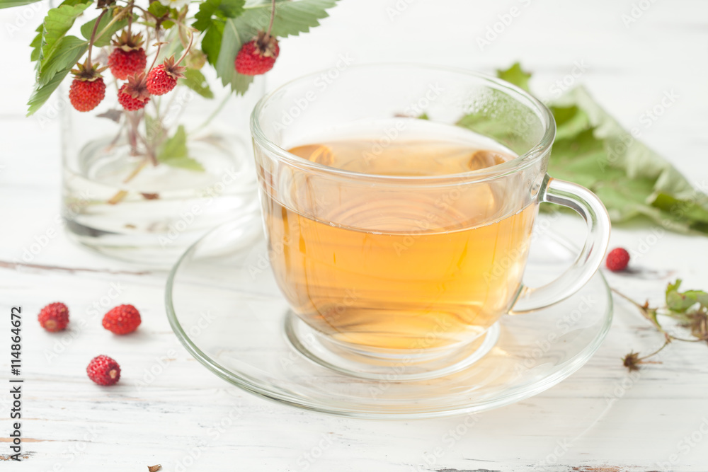 drink with wild strawberry on a white wooden table