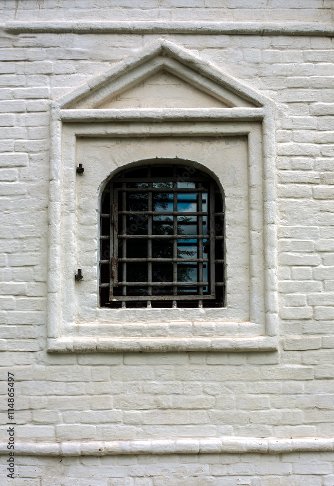 Single barred window in brick wall