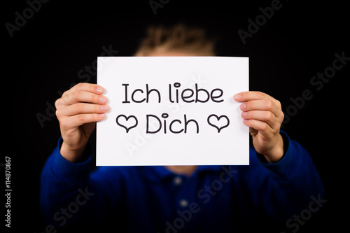 Child holding sign with German words Ich liebe Dich - I Love You
