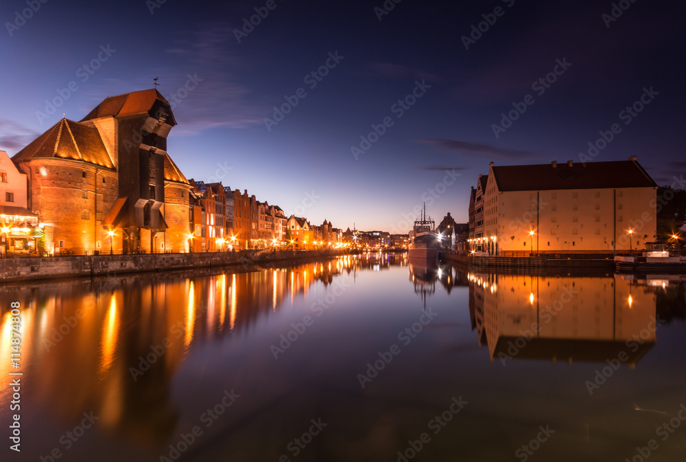 Gdansk old town with harbor and medieval crane in the night.