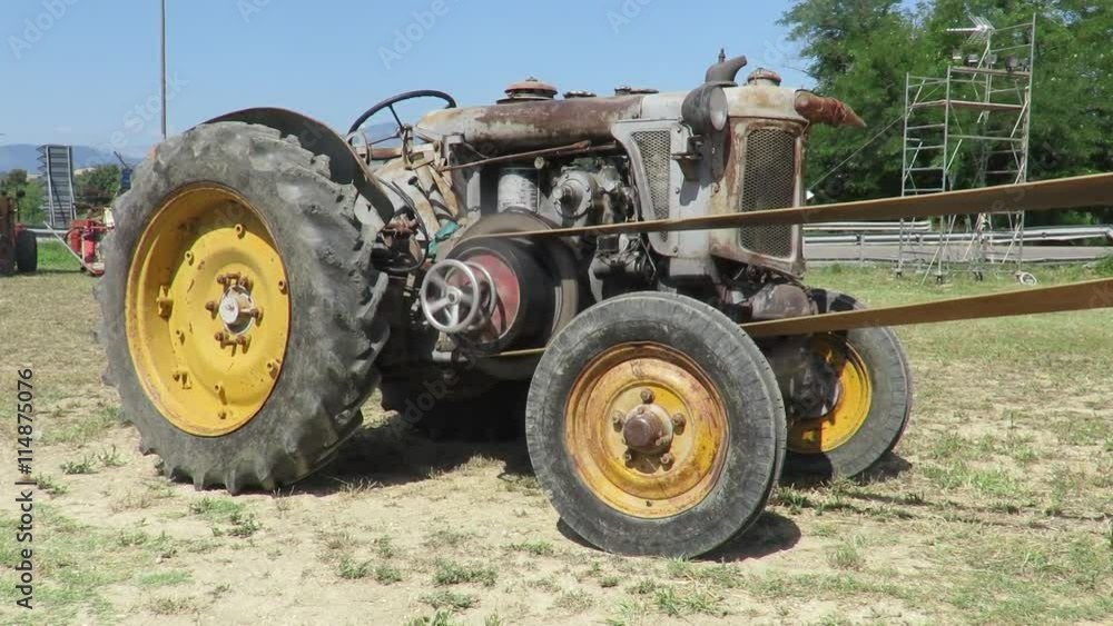 Old wheeled tractor used for threshing Old wheeled tractor used for threshing
