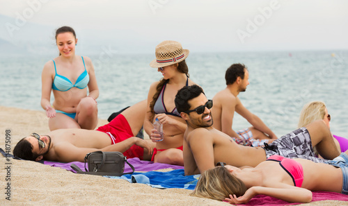 Friends relaxing at sandy beach © JackF
