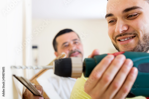 Two skilled men doing maintenance © JackF