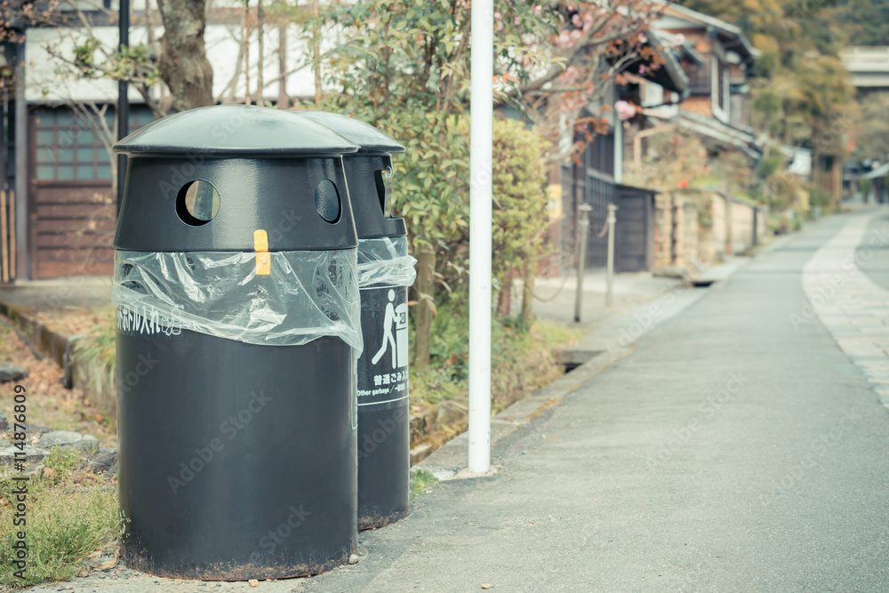 Closeup black trash can with plastic bag Closeup black trash can with plastic bag