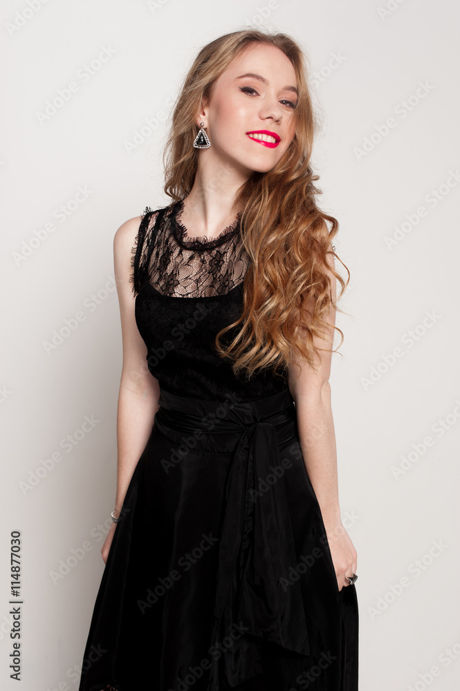 Portrait of beautiful young blonde girl in black dress. Fashion photo Portrait of beautiful young blonde girl in black dress. Fashion photo