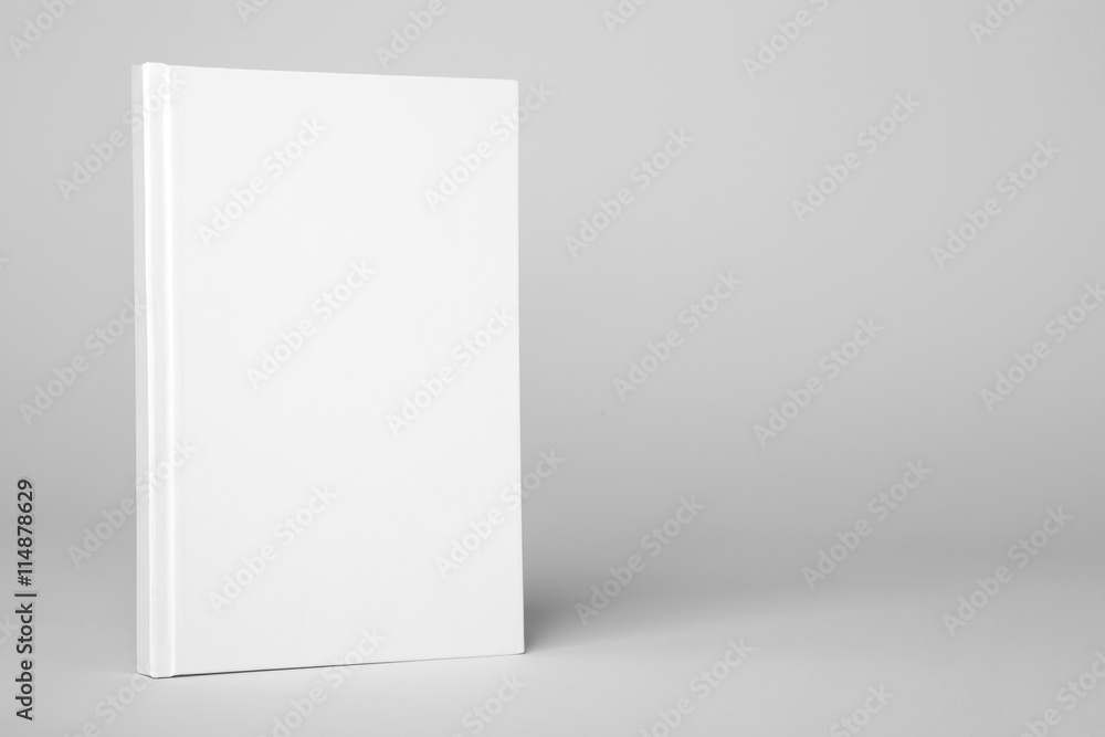 Obraz premium Real hardcover white book on a gray background