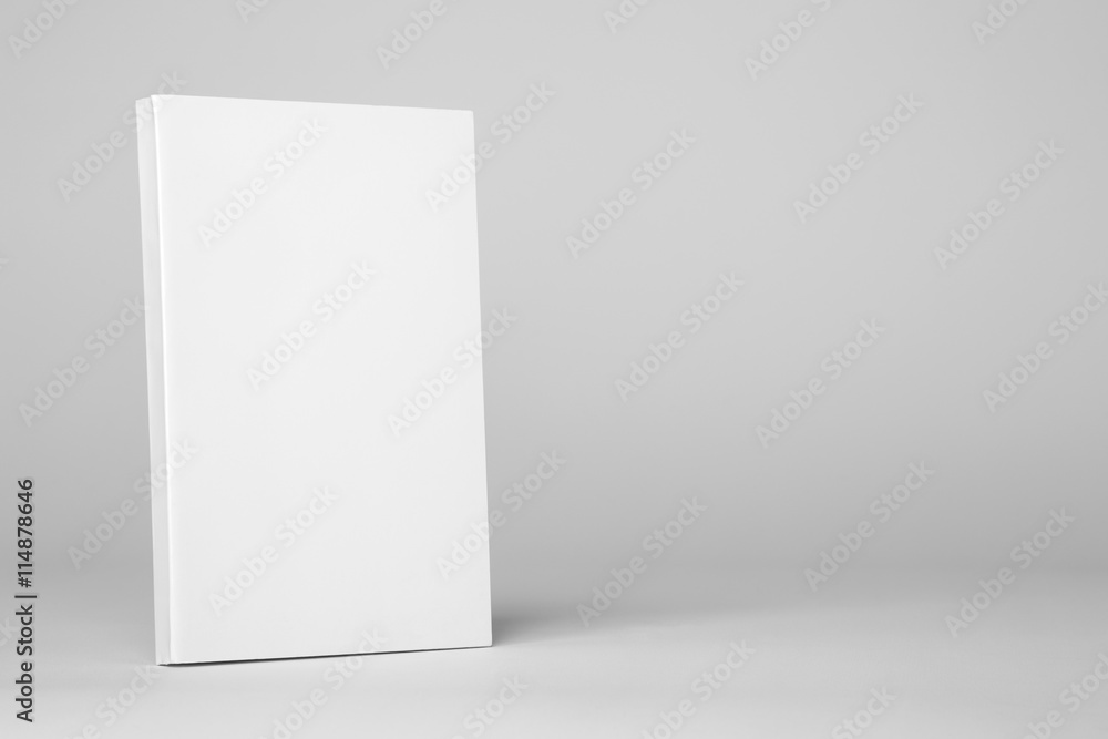 Fototapeta premium Real paperback white book on a gray background
