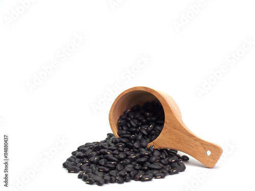 black bean  , Placed on a wooden spoon , on white background. photo